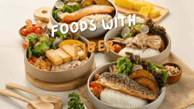 Healthy meals The Best Foods with Fiber for Better Digestion and Health in bowls featuring rice, leafy greens, grilled fish, tofu, and vegetables, arranged on a wooden table.